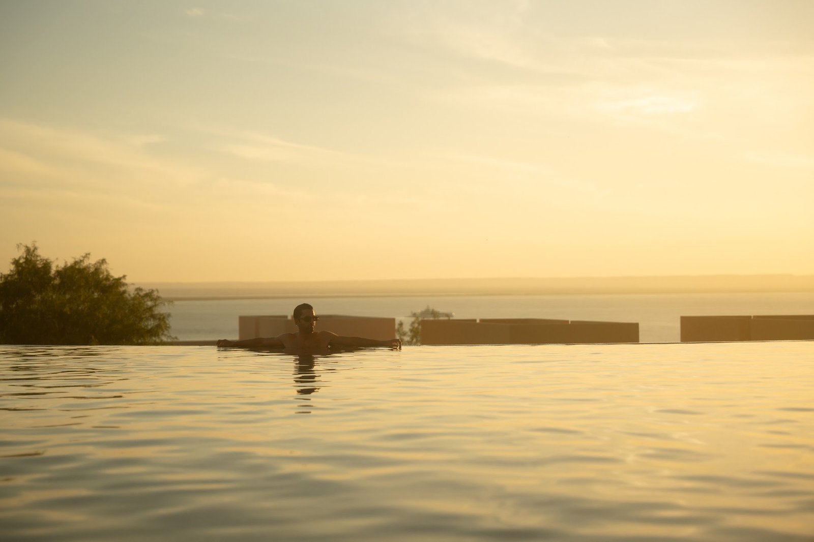 Swimming at the infinity edge at sunset