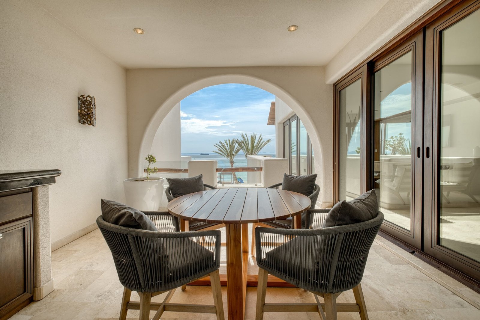 Dining nook with arched window to the sea
